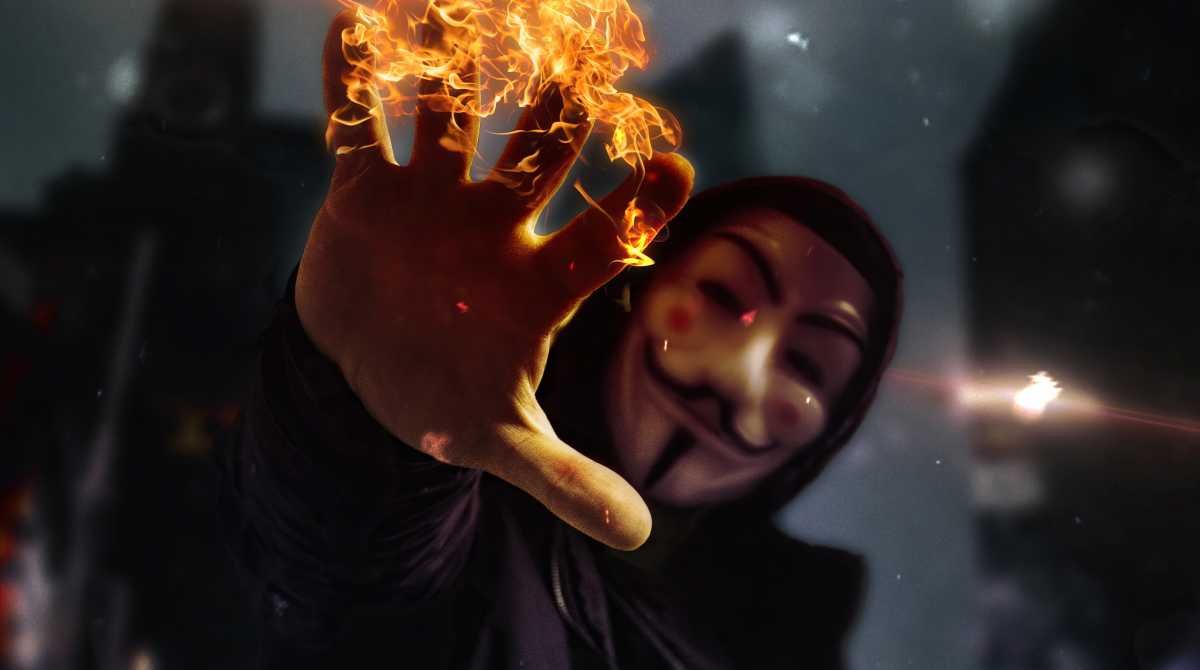anonymous-mask-burning-hand